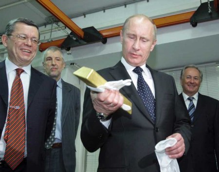 Putin holds a gold ignot